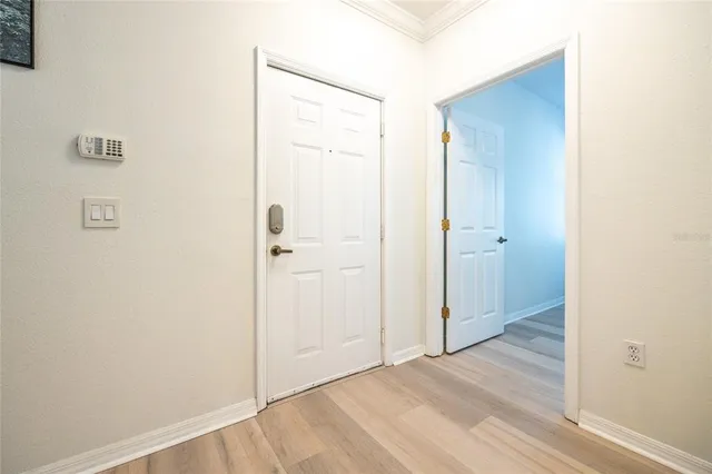 a living room with furniture a flat screen tv and a window
