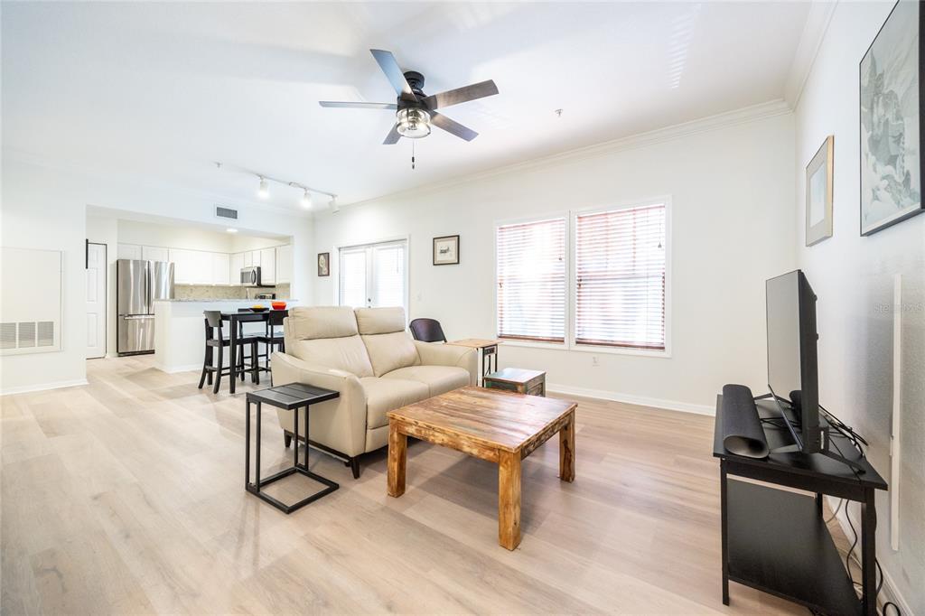 4850 Southwest 91 Terrace, Unit P201 Gainesville, FL 32608 - Photo 7 of 33 a living room with furniture a flat screen tv and a window