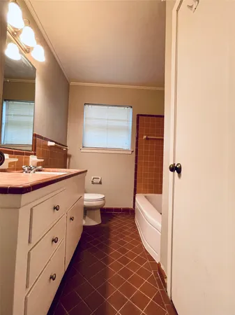 a bathroom with a double vanity sink toilet and shower