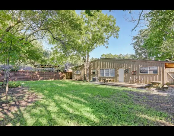 a view of a house with backyard and sitting area