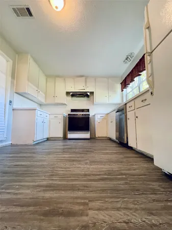 a view of a kitchen with electric appliances