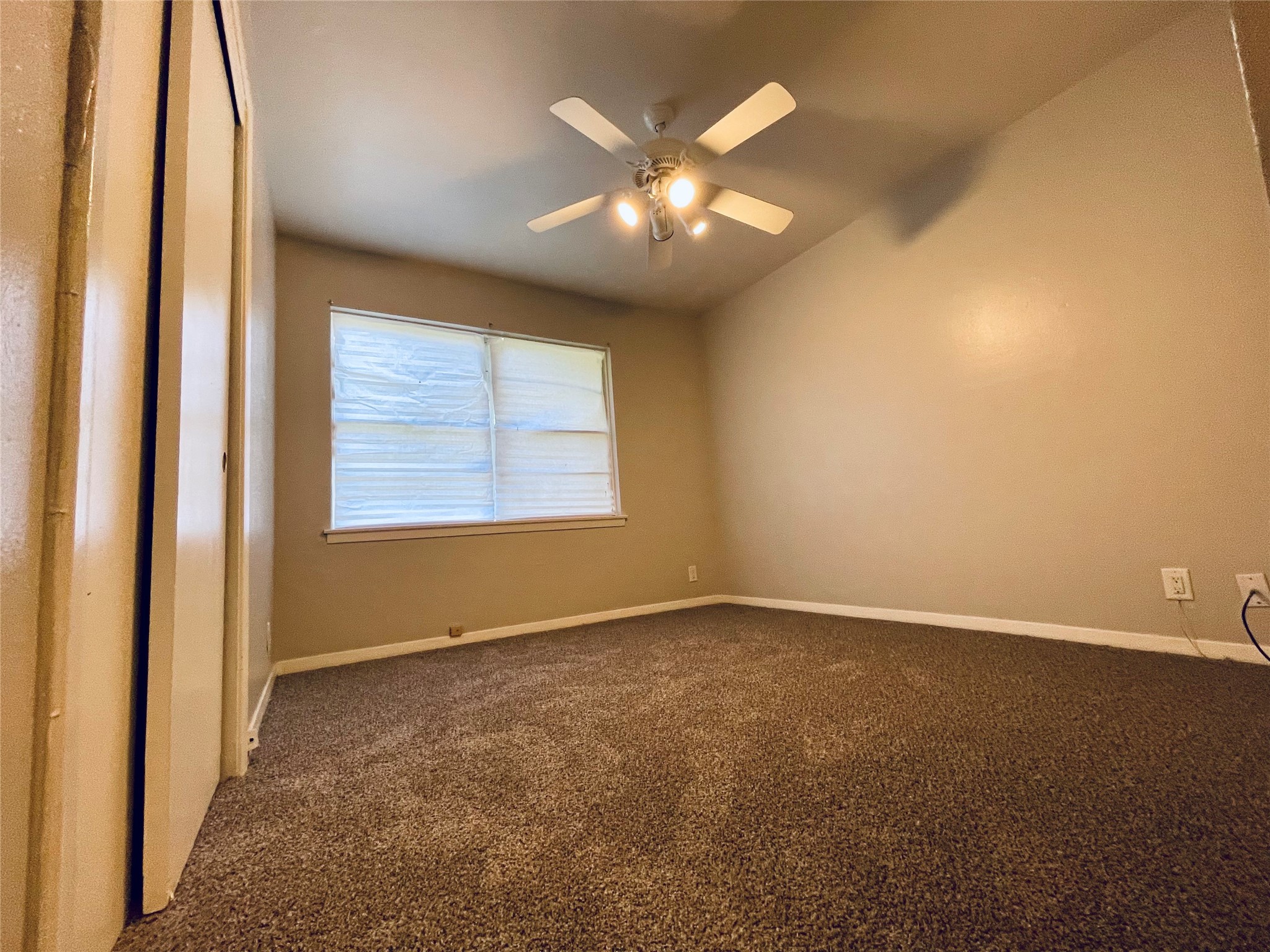 5406 Carew Street Houston, TX 77096 - Photo 10 of 18 an empty room with windows and chandelier fan