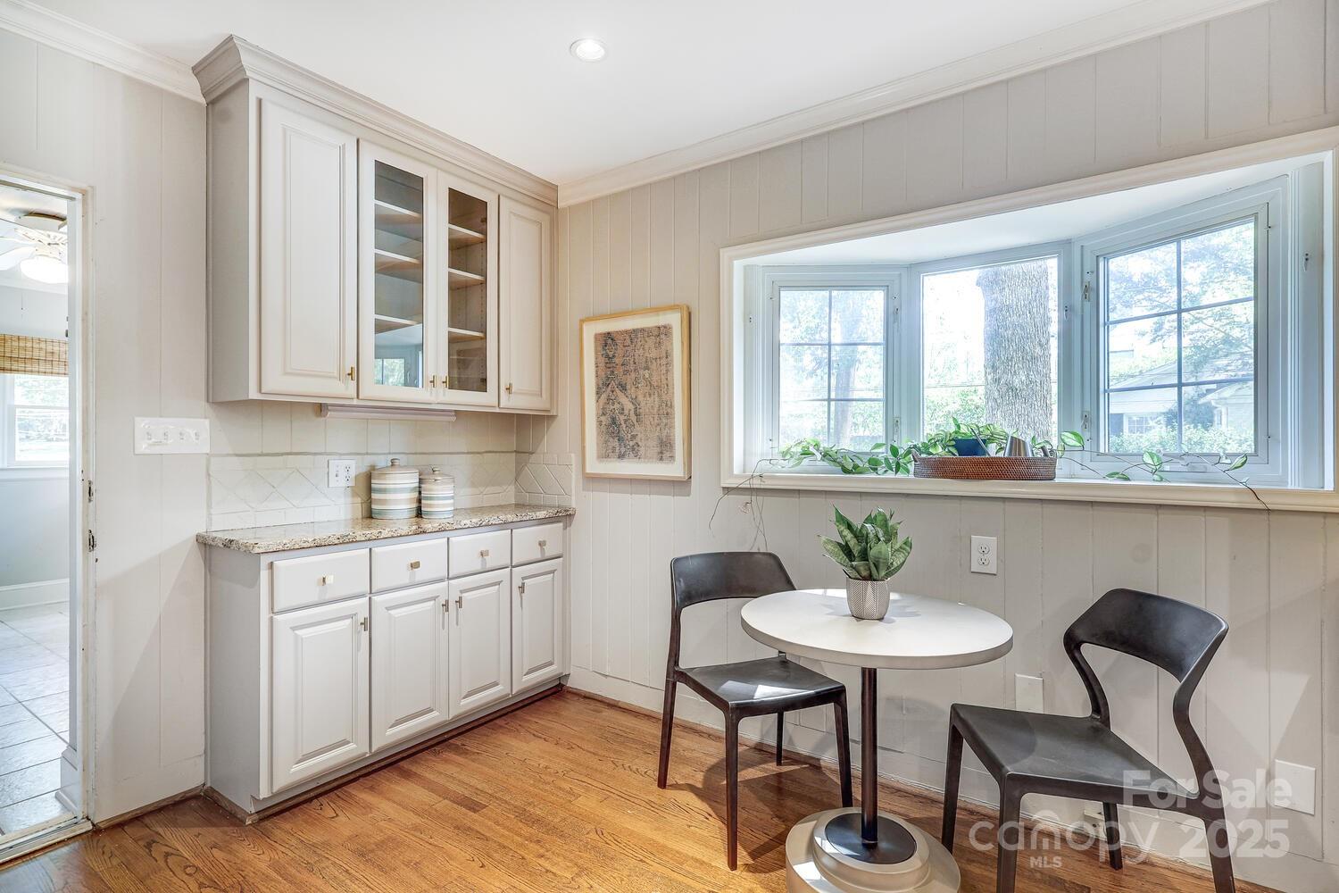 500 Ellsworth Road Charlotte, NC 28211 - Photo 13 of 40 a kitchen with a dining table chairs and white appliances