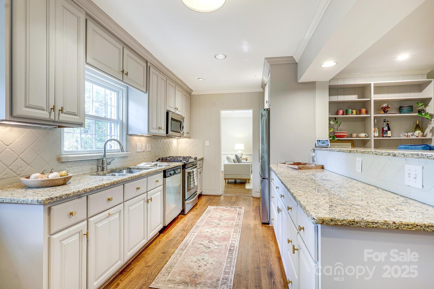 500 Ellsworth Road Charlotte, NC 28211 - Photo 15 of 40 a large kitchen with stainless steel appliances granite countertop a sink and cabinets