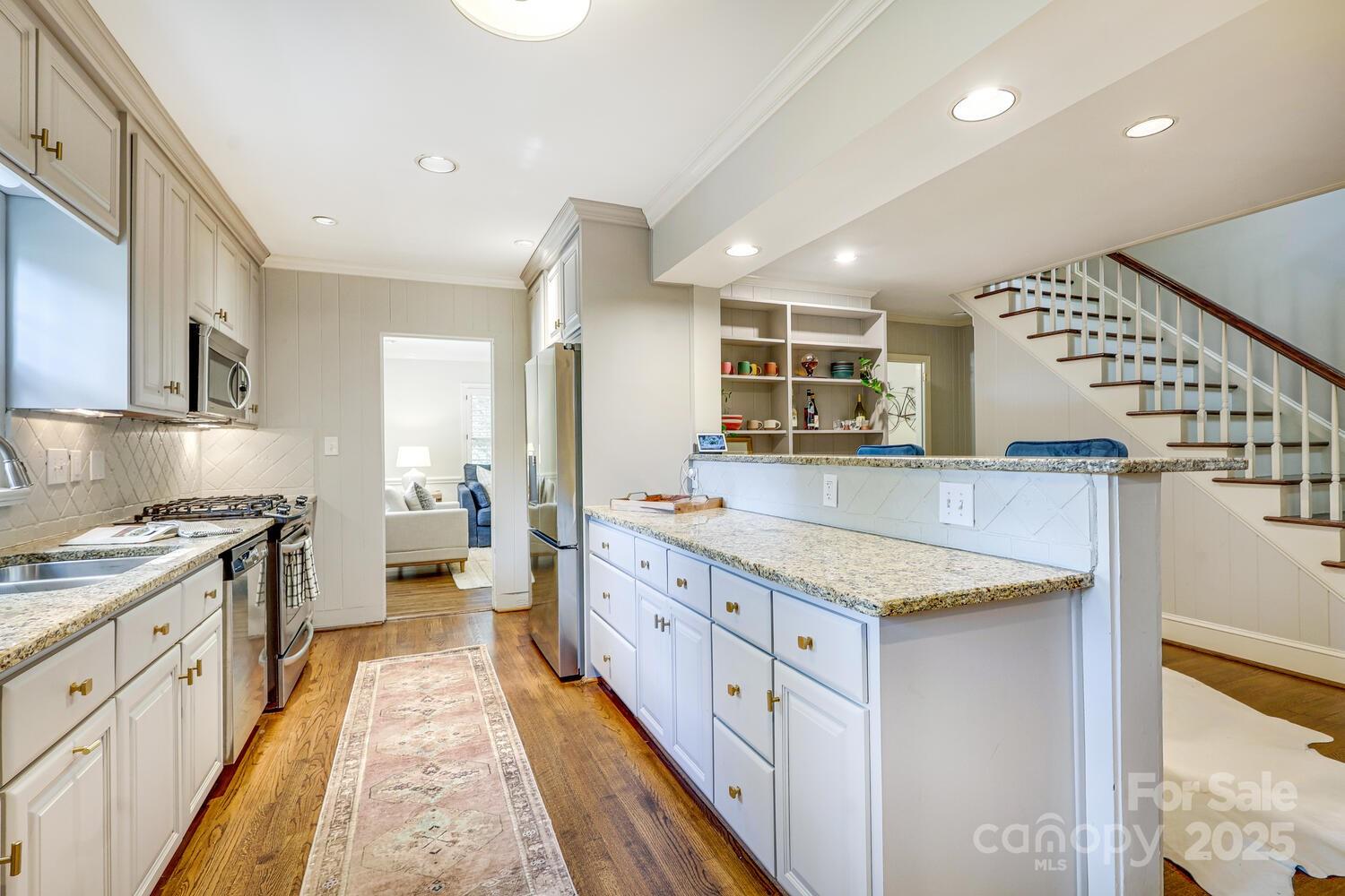 500 Ellsworth Road Charlotte, NC 28211 - Photo 16 of 40 a large kitchen with stainless steel appliances granite countertop a large counter top a stove and a sink
