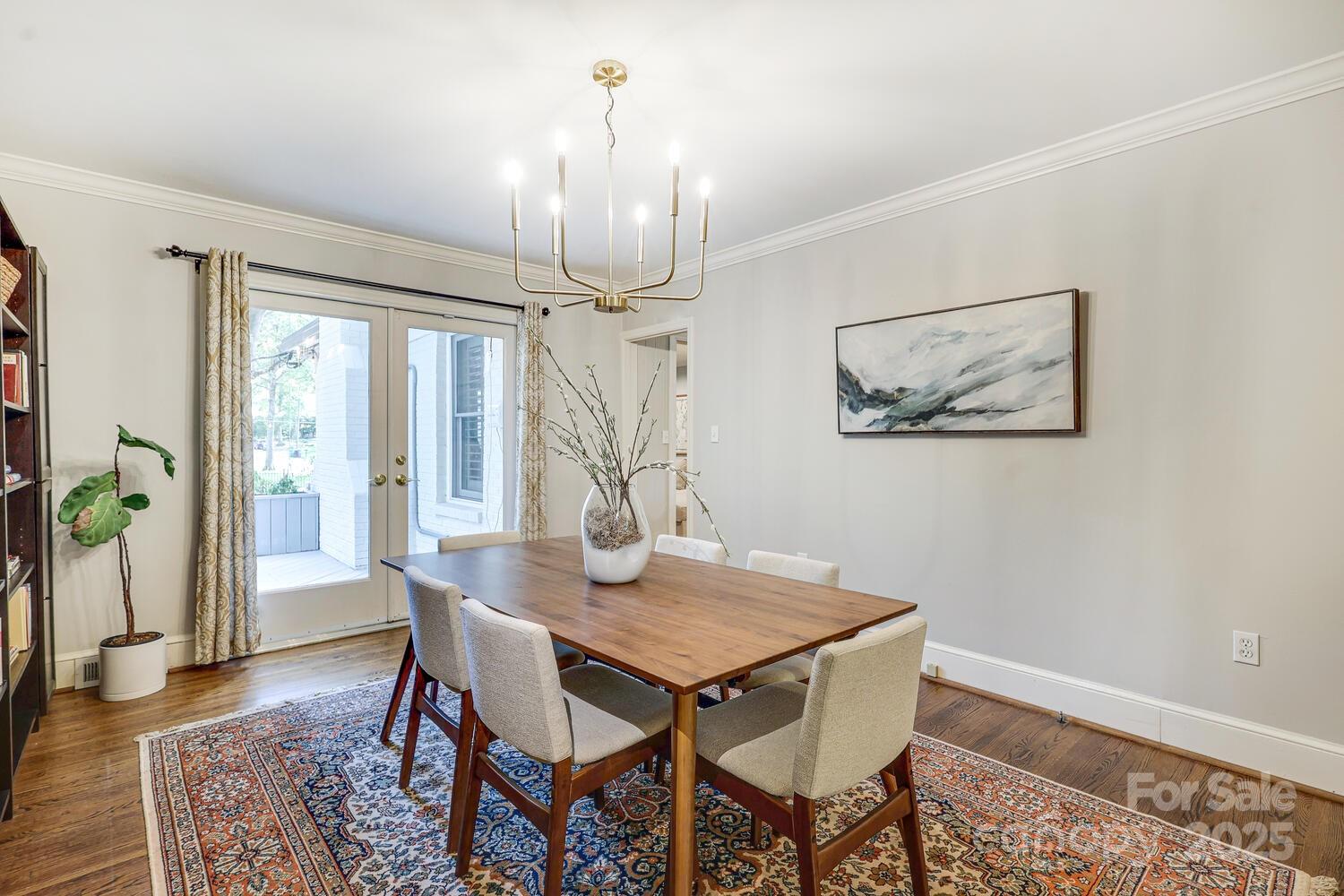 500 Ellsworth Road Charlotte, NC 28211 - Photo 18 of 40 a view of a dining room with furniture wooden floor and chandelier