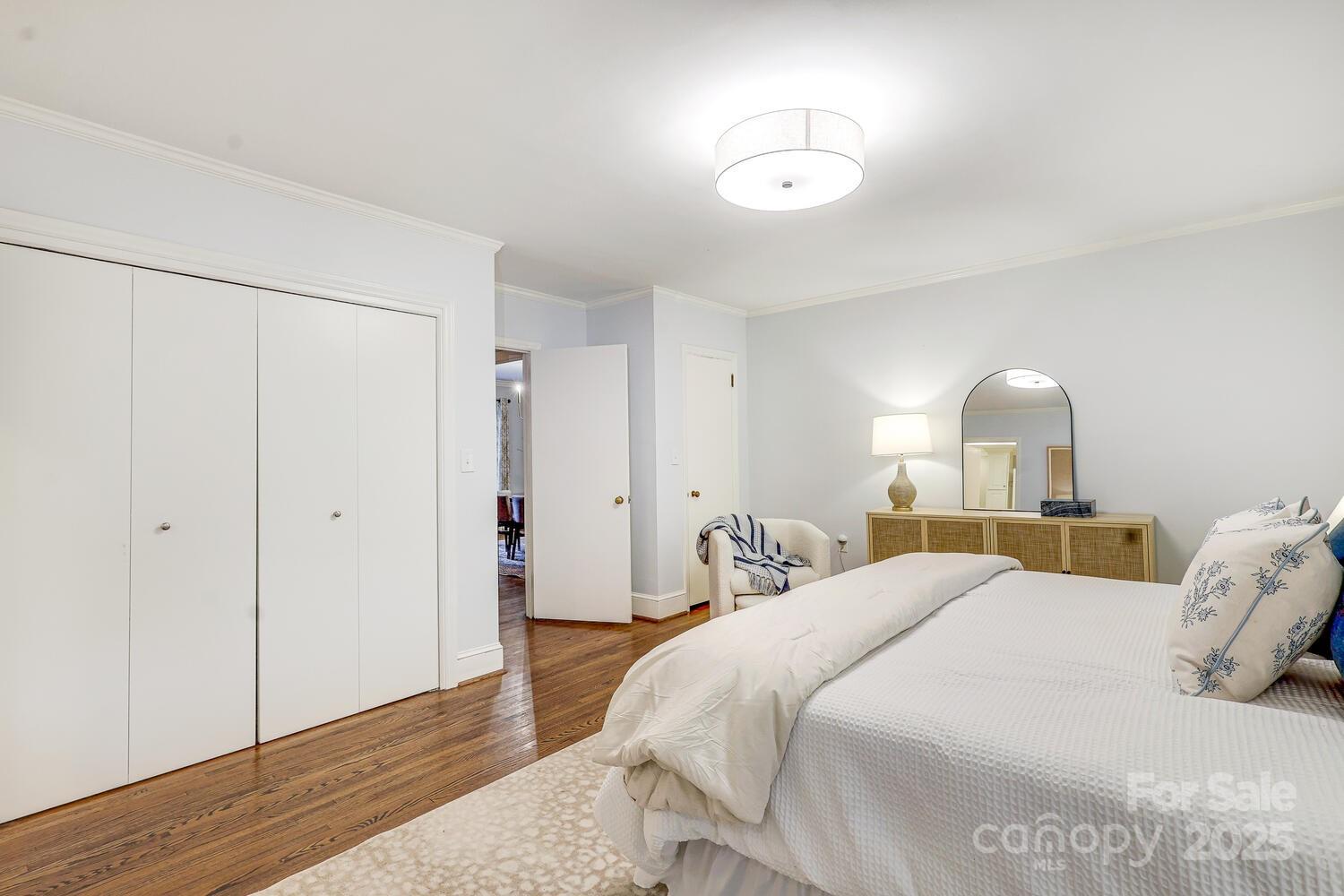 500 Ellsworth Road Charlotte, NC 28211 - Photo 21 of 40 a bedroom with a bed and a chandelier