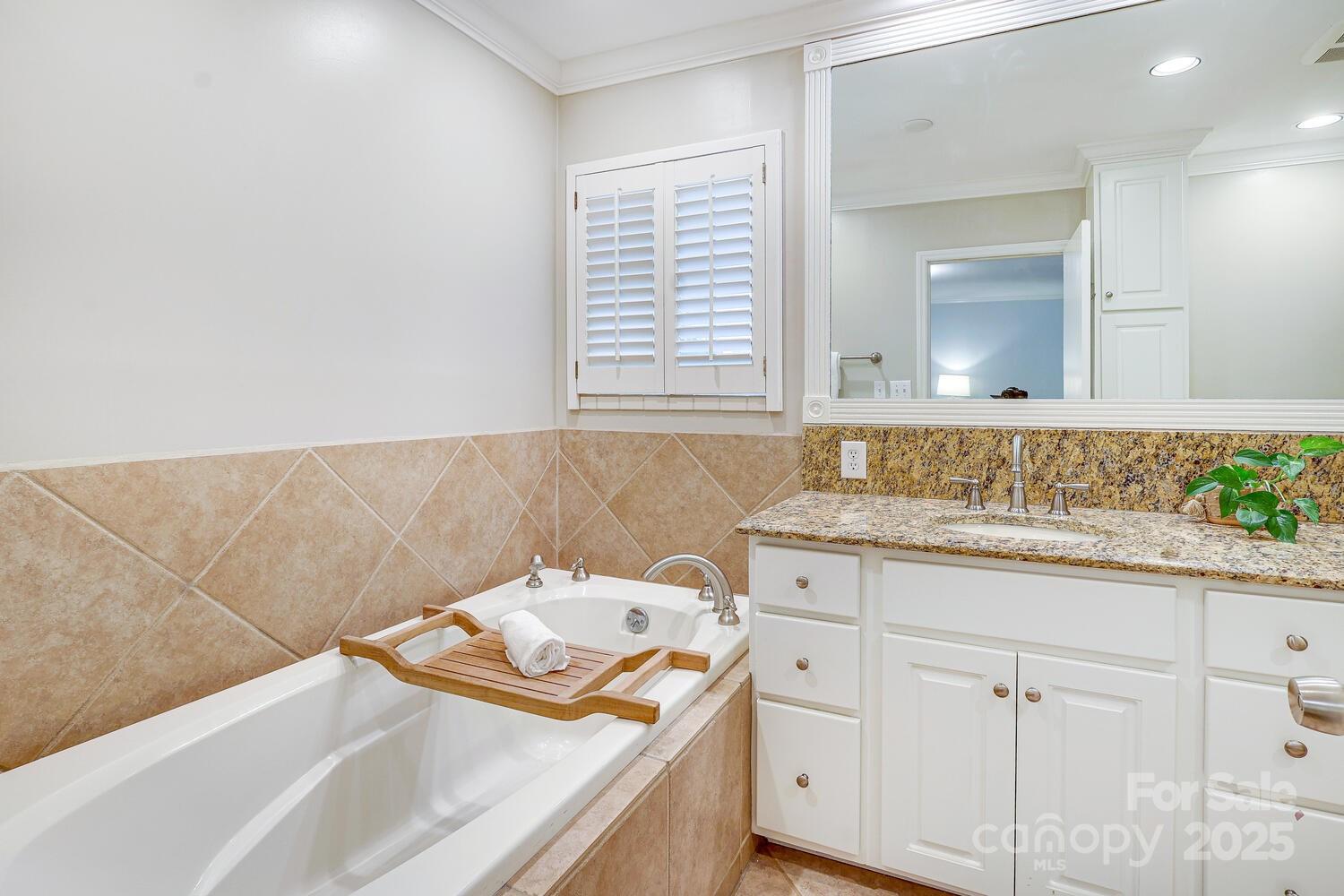 500 Ellsworth Road Charlotte, NC 28211 - Photo 24 of 40 a bathroom with a sink and a mirror