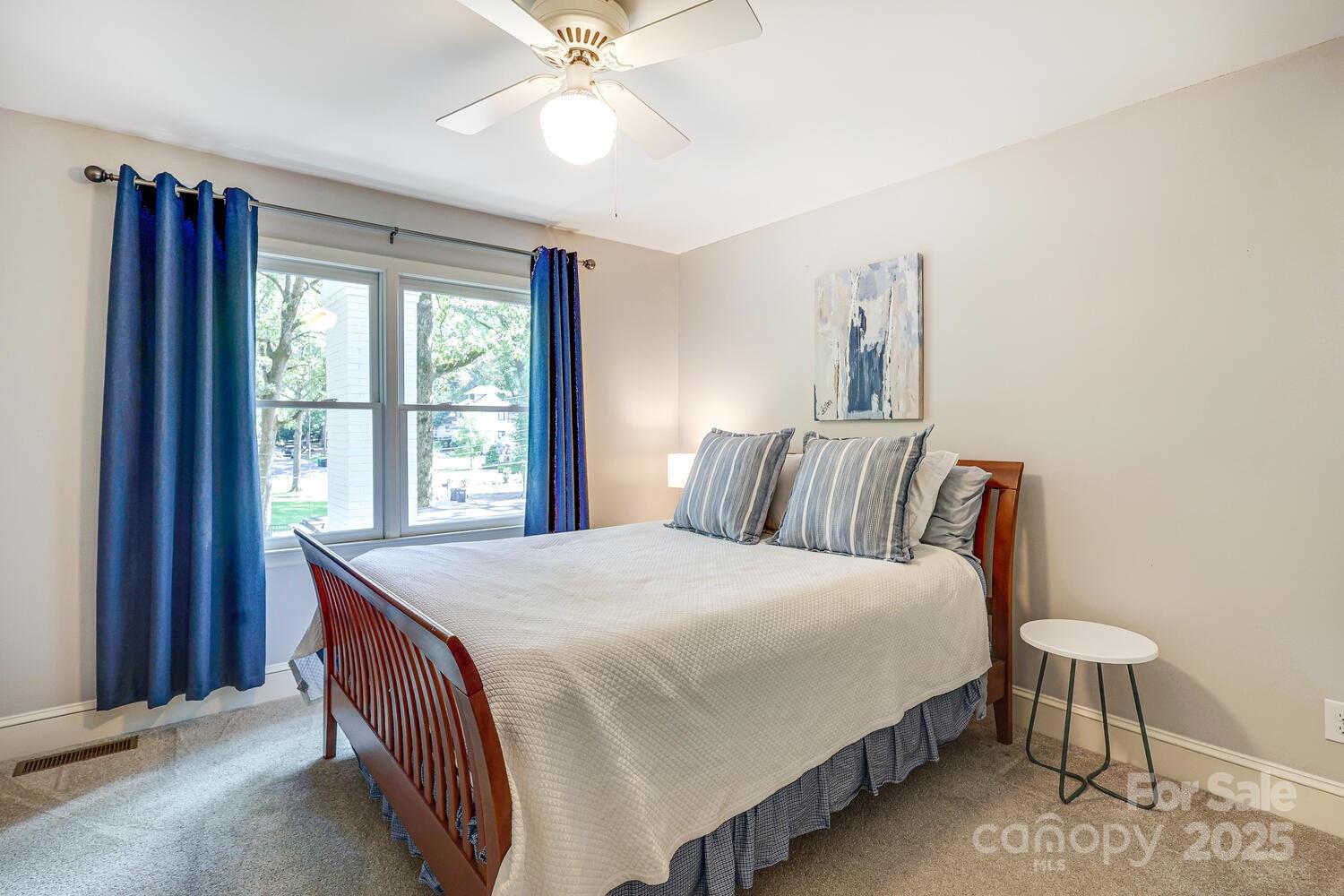 500 Ellsworth Road Charlotte, NC 28211 - Photo 28 of 40 a bedroom with a bed and a chandelier