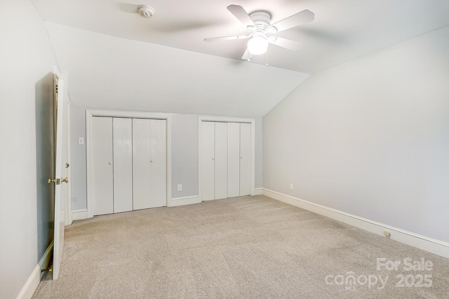 500 Ellsworth Road Charlotte, NC 28211 - Photo 31 of 40 an empty room with a chandelier fan and closet