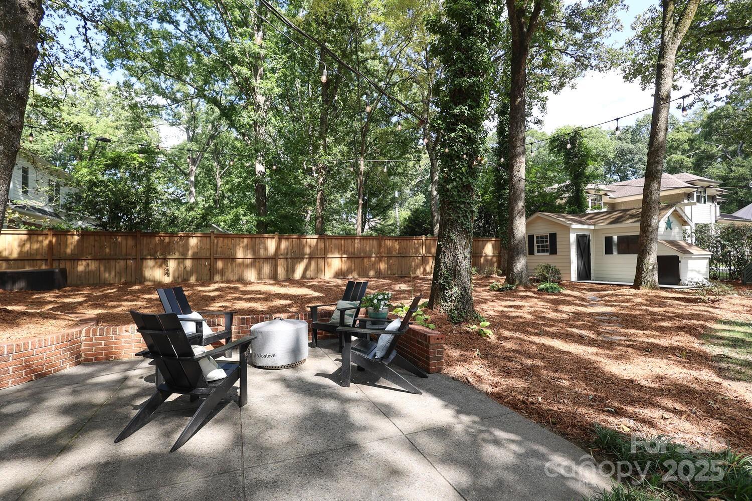 500 Ellsworth Road Charlotte, NC 28211 - Photo 35 of 40 a view of a patio with table and chairs and floor to ceiling window