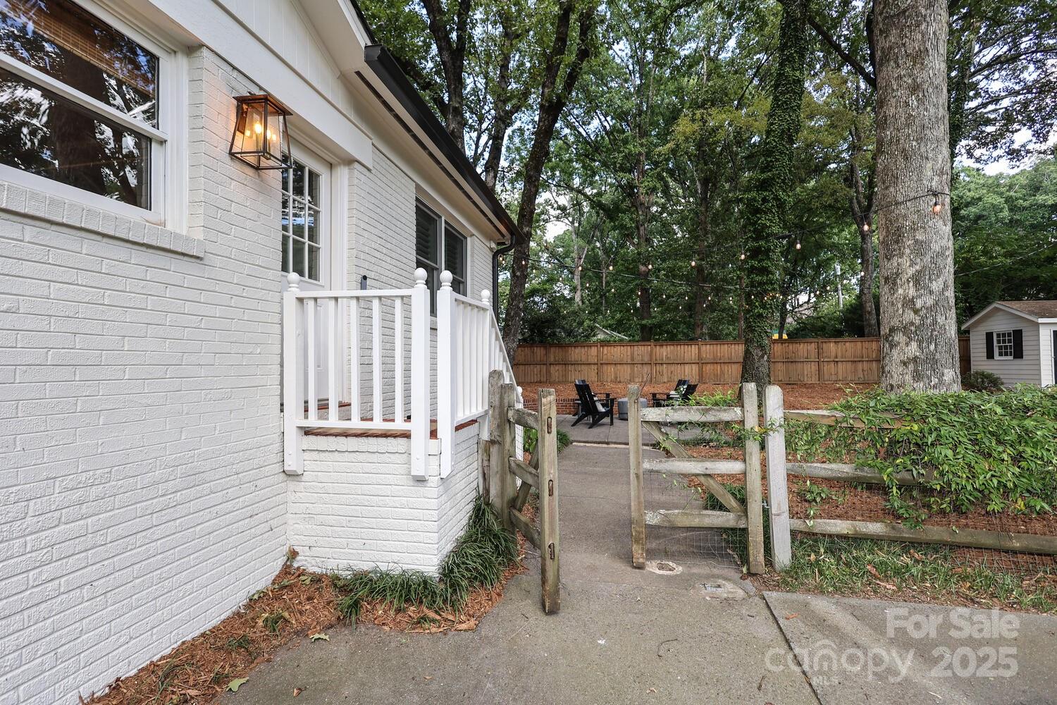 500 Ellsworth Road Charlotte, NC 28211 - Photo 39 of 40 a view of a chairs and table in backyard of the house