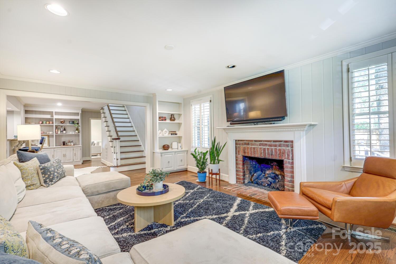 500 Ellsworth Road Charlotte, NC 28211 - Photo 9 of 40 a living room with furniture a fireplace and a flat screen tv