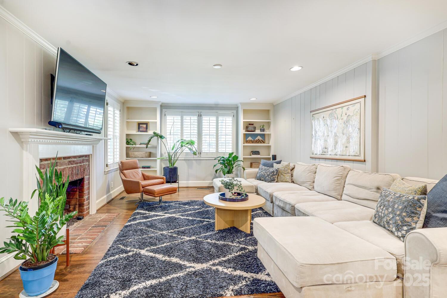 500 Ellsworth Road Charlotte, NC 28211 - Photo 10 of 40 a living room with furniture a fireplace and a potted plant