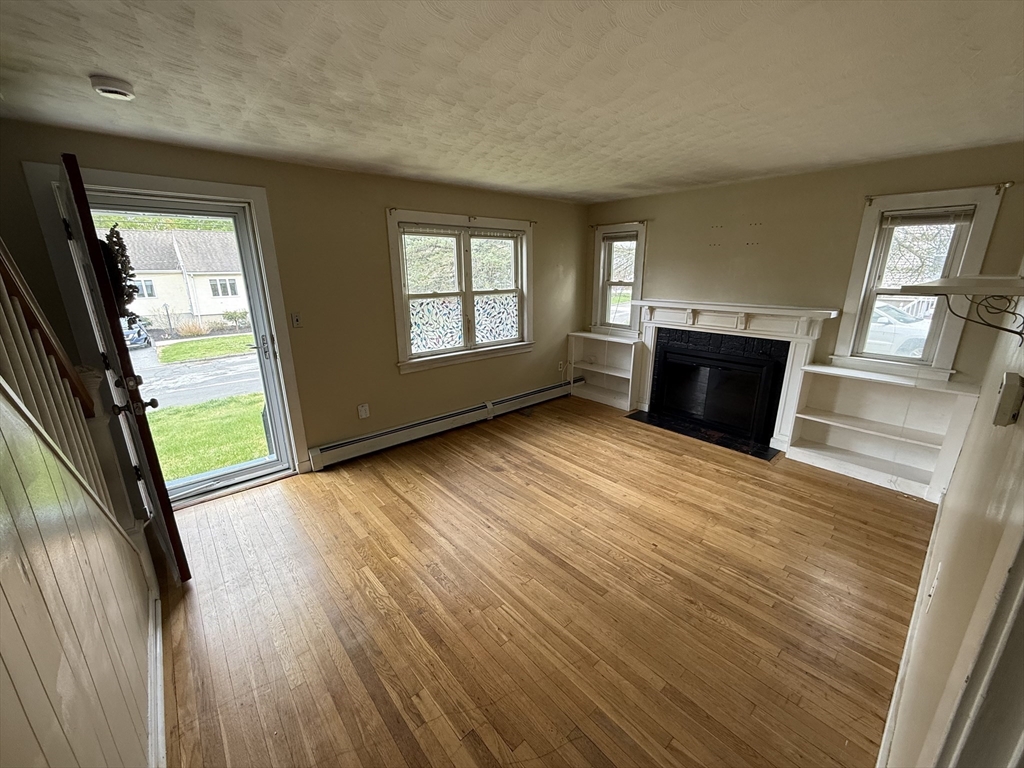 43 Manor Road Shrewsbury, MA 01545 - Photo 5 of 16 wooden floor in an empty room with a window