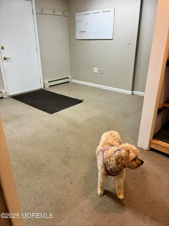 a view of a room with wooden floor