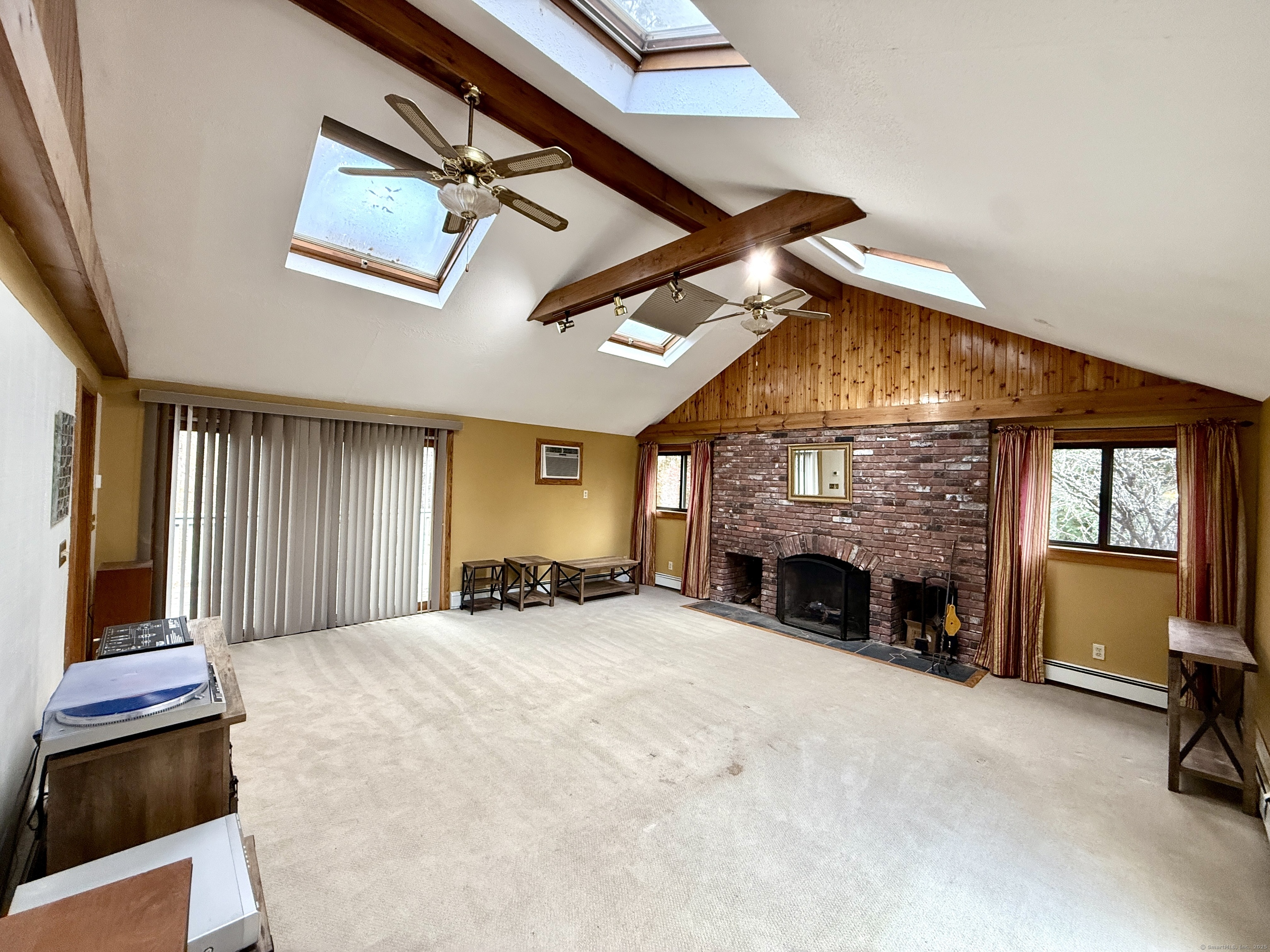 102 Krapf Road Ashford, CT 06278 - Photo 16 of 39 a view of an empty room with a fireplace and a window