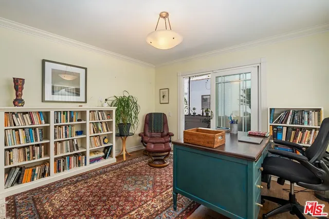 a living room with furniture and a book shelf
