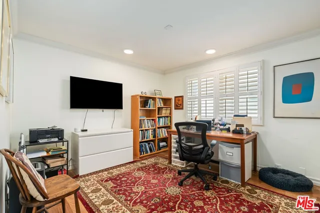 a view of a livingroom with workspace and a window