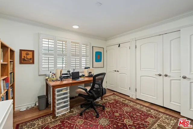 a view of a workspace with furniture and a window
