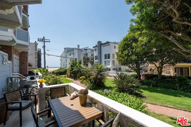 a view of a patio with table and chairs and potted plants
