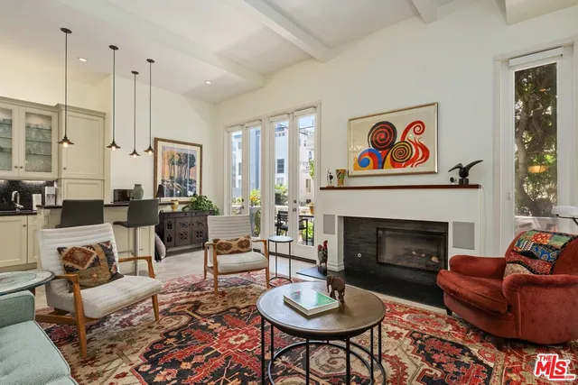 a living room with furniture fireplace and window