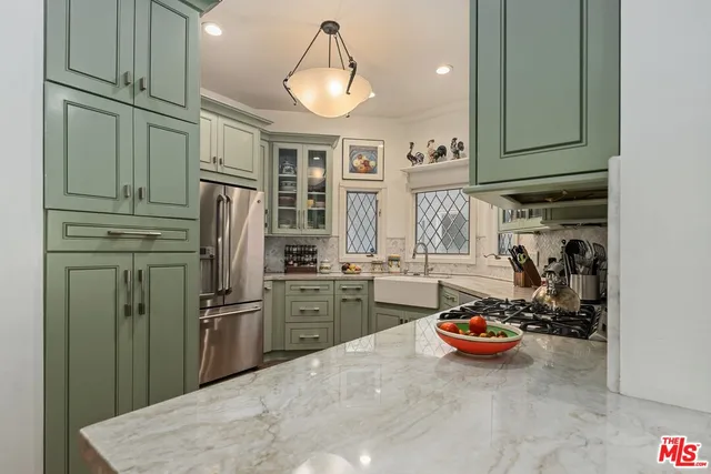 a kitchen with refrigerator and window