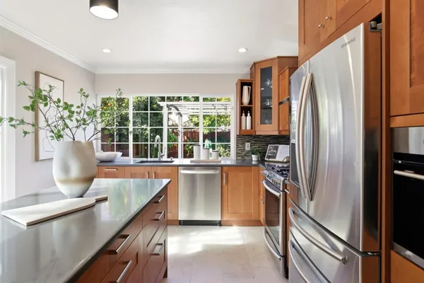 a kitchen with stainless steel appliances granite countertop a refrigerator and a sink
