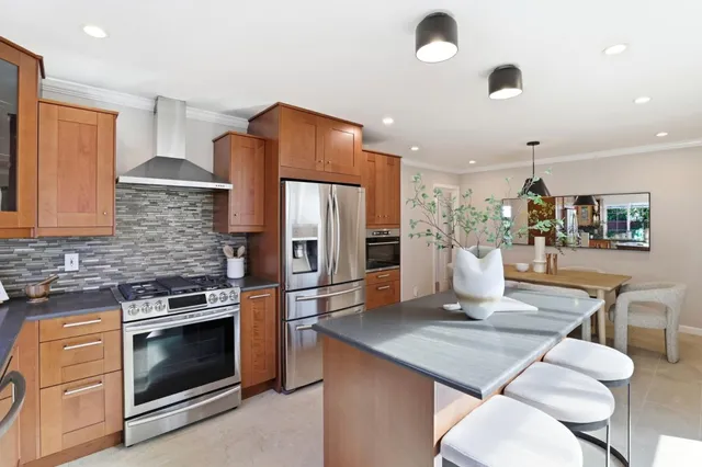 a backyard of a house with table and chairs