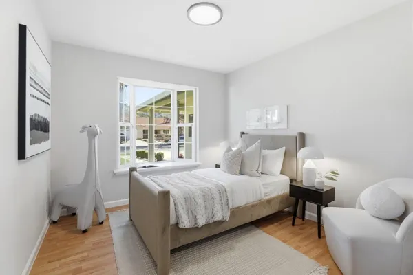a bedroom with a bed and wooden floor