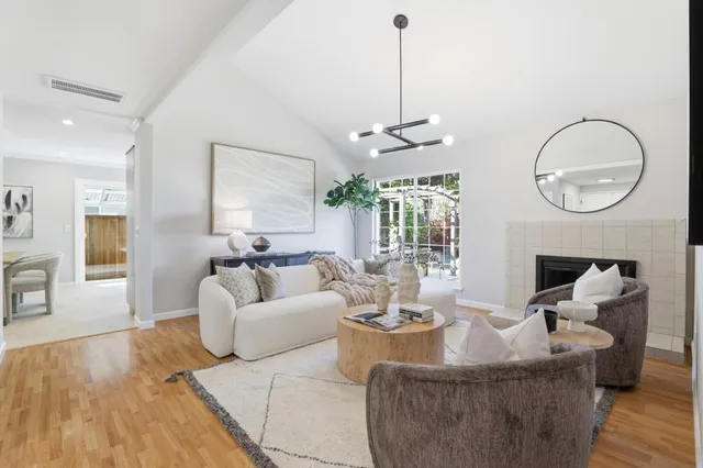 a living room with furniture and a wooden floor