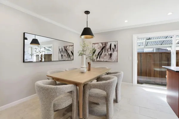 a dining room with furniture and window