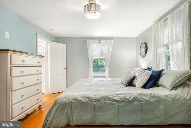 a bedroom with a large bed and a window