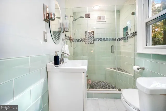 a bathroom with a shower toilet and sink
