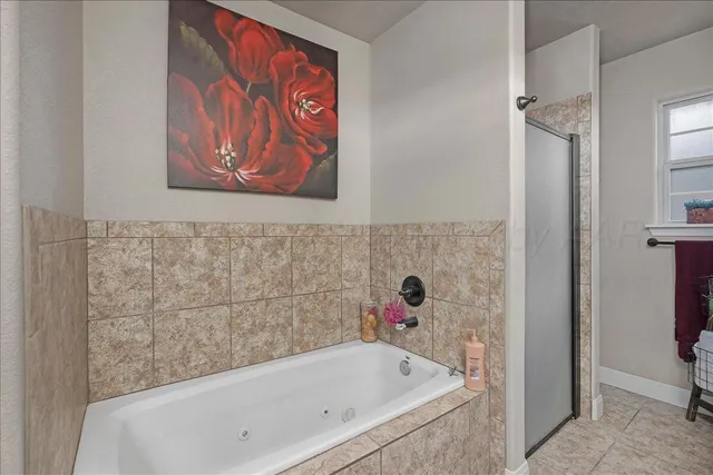 a bathroom with a bathtub and shower