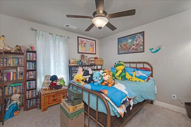 a bedroom with furniture and a book shelf