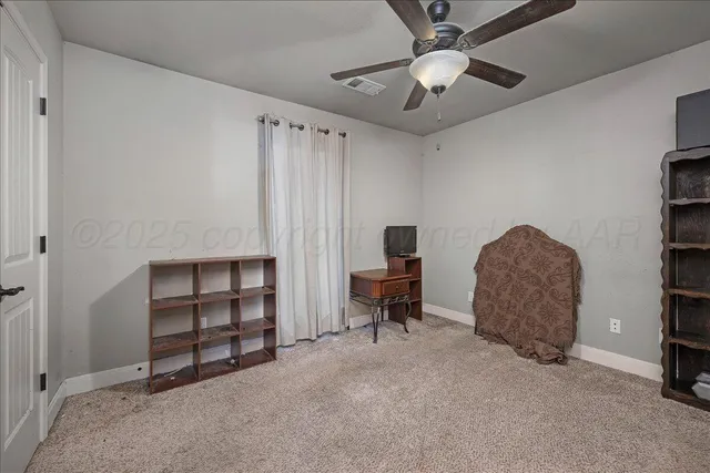 a living room with furniture and a ceiling fan