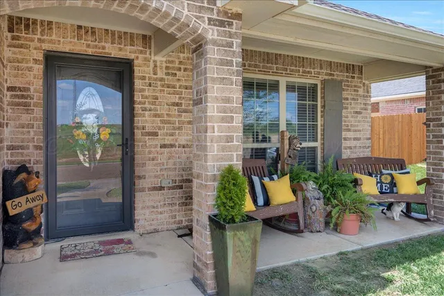 front view of a brick house with outdoor seating space