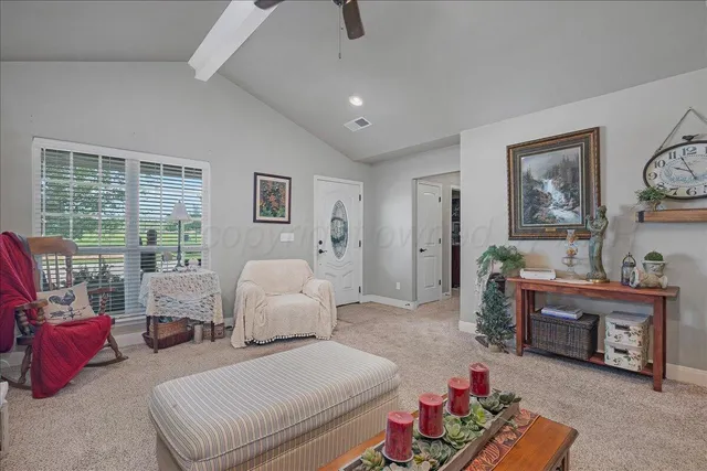 a bedroom with furniture and a large window