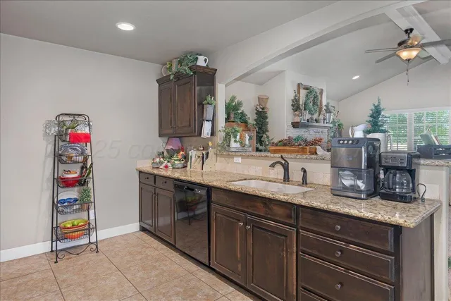 a bathroom with a granite countertop double vanity sink and a mirror