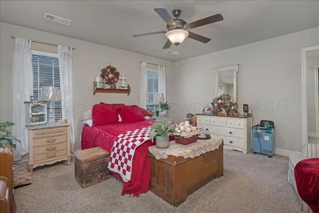 a living room with furniture chandelier and a window