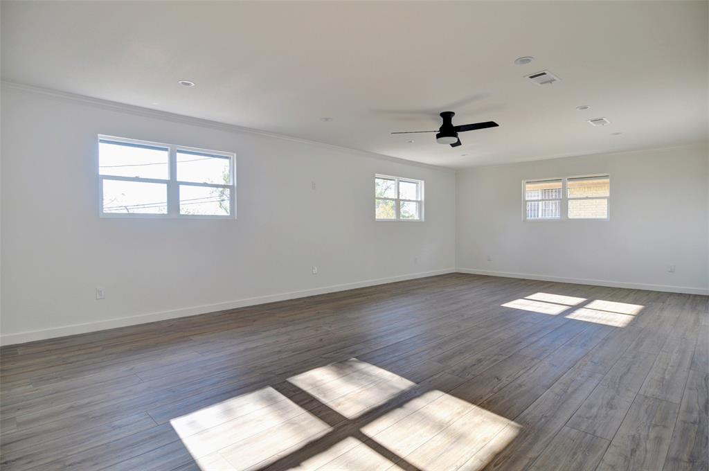 5549 Sam Calloway Road Fort Worth, TX 76114 - Photo 12 of 31 a view of wooden floor and windows in an empty room