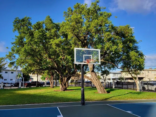 a front view of a house with a garden and trees