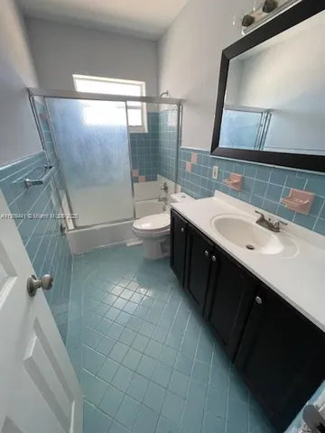 a spacious bathroom with a double vanity sink toilet mirror and shower