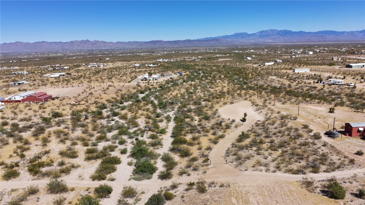 1386 Don Luis Road Golden Valley, AZ 86413 - Photo 33 of 47 Expansive desert landscape with scattered vegetation, visible mountains in the distance, and a clear blue sky