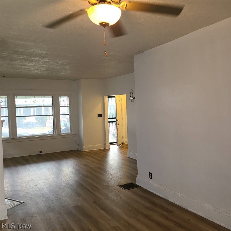 16308 Nela View Road Cleveland, OH 44112 - Photo 5 of 13 Spacious interior featuring wood-finish flooring, white walls, and a ceiling fan with integrated lighting
