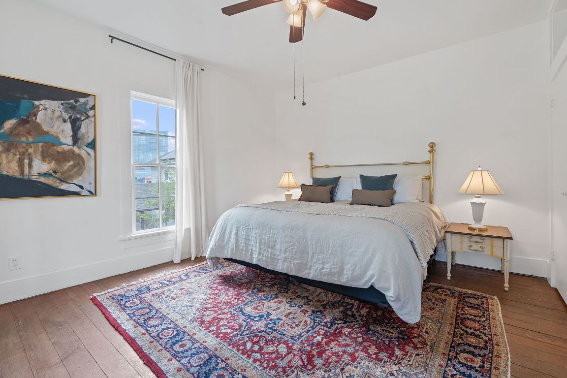 810 East 13th Street Austin, TX 78702 - Photo 22 of 39 a bedroom with a large bed and a chandelier