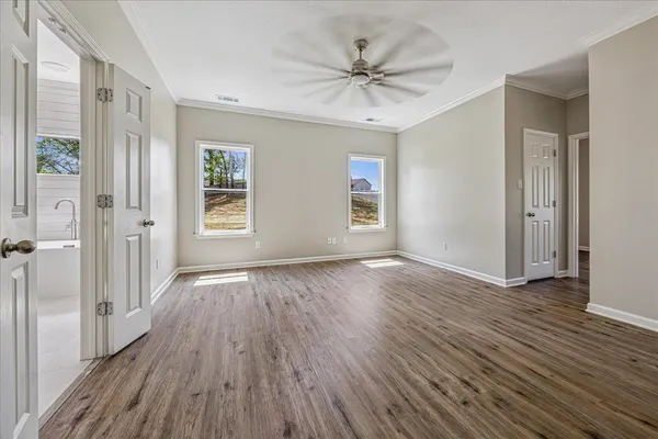 wooden floor in an empty room with a window