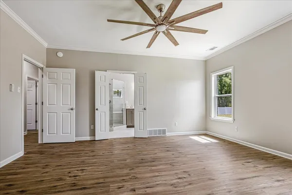 wooden floor in an empty room with a window