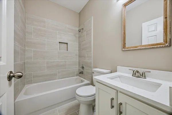 a bathroom with a sink a toilet and a bathtub